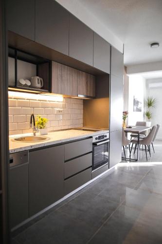 a kitchen with a sink and a table in it at Allure Apartments in Ulcinj