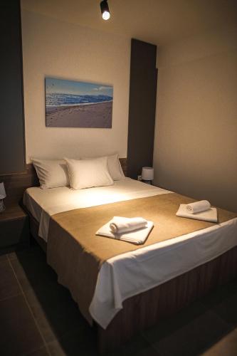 a bedroom with a bed with two towels on it at Allure Apartments in Ulcinj