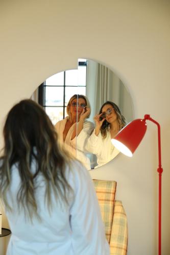 a woman taking a picture in front of a mirror at Virgin Hotels New Orleans in New Orleans