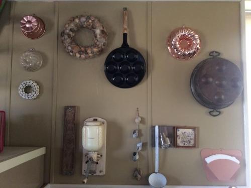 a wall with plates and pans hanging on a wall at Dijkhuisje Zeeland in Waterlandkerkje