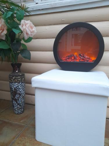 a fire pit sitting on top of a white stool at Country Dream - Langholt 2 in Selfoss