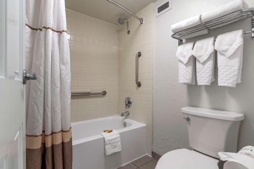 a bathroom with a tub and a toilet and a shower at Best Western Plus Hilltop Inn in Redding