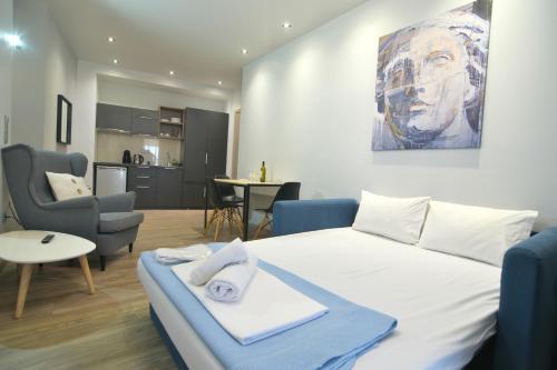 a bedroom with a bed and a living room at Feel Athens Studios at Monastiraki in Athens