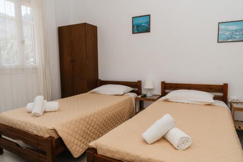 a bedroom with two beds with towels on them at Oasis in Kamarai