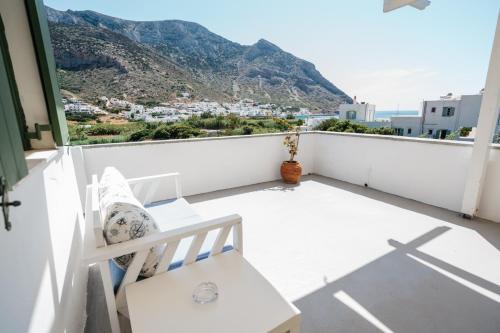 a white balcony with a view of a mountain at Oasis in Kamarai