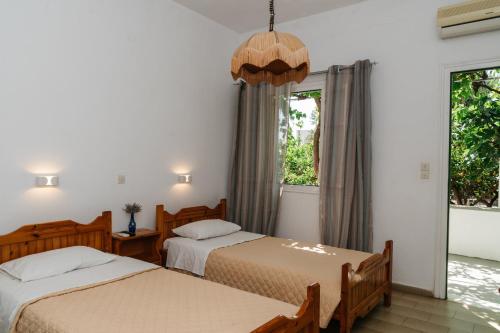 a bedroom with two beds and a window at Oasis in Kamares