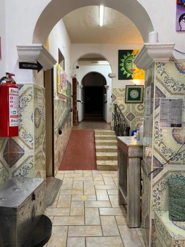 a hallway of a building with a tile floor at Hotel del Sol in San Miguel de Allende