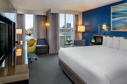 a hotel room with a large bed and a window at The Royal Sonesta Boston in Cambridge