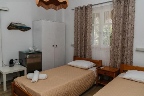 a bedroom with two beds and a window at Oasis in Kamarai
