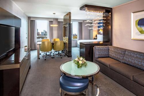 a living room with a couch and a table at The Royal Sonesta Boston in Cambridge