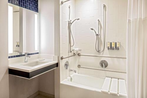 a bathroom with a sink and a tub and a shower at The Royal Sonesta Boston in Cambridge