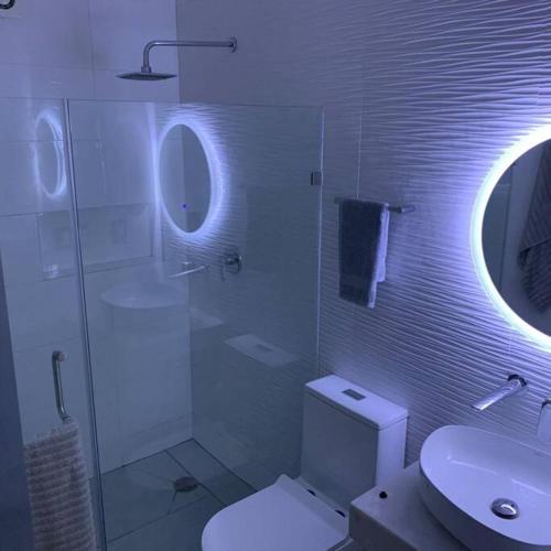 a bathroom with a toilet and a sink and a mirror at Playa sur, 5 min playa camina, machado, olas! in Mazatlán
