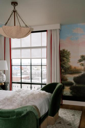 a bedroom with a bed and a large window at Virgin Hotels New Orleans in New Orleans