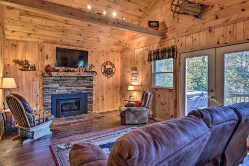 a living room with a couch and a fireplace at Natures Retreat with Hot Tub 7 Mi to Bryson City in Whittier