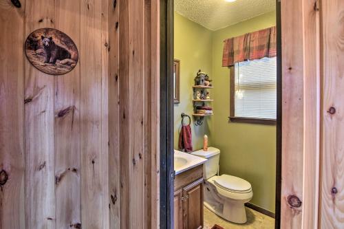 a bathroom with wooden walls and a toilet and a sink at Natures Retreat with Hot Tub 7 Mi to Bryson City in Whittier
