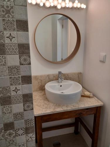 a bathroom with a sink and a mirror at ADEGA Residências Artísticas - Perto de Lisboa in Almargem