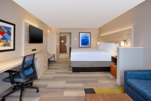 a hotel room with a bed and a desk at Holiday Inn Express & Suites Wooster by IHG in Wooster