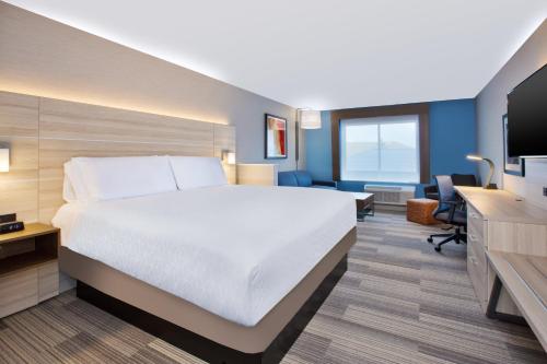 a hotel room with a bed and a desk at Holiday Inn Express & Suites Wooster by IHG in Wooster