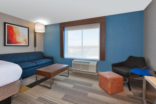 a hotel room with a bed and a couch at Holiday Inn Express & Suites Wooster by IHG in Wooster