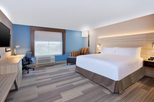 a hotel room with a bed and a television at Holiday Inn Express & Suites Wooster by IHG in Wooster