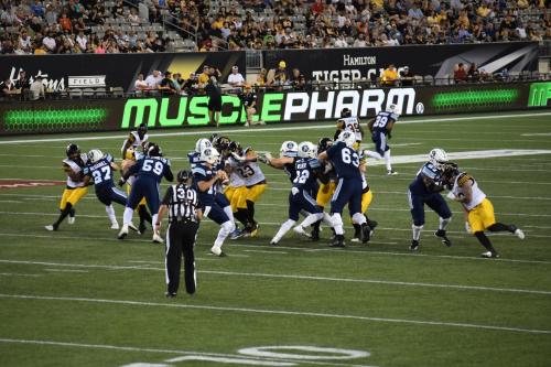 a group of football players on a field at Staybridge Suites Hamilton - Downtown by IHG in Hamilton