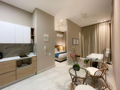a living room with a kitchen and a bedroom at FR Hotel in Ibagué