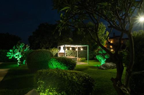 a garden at night with green lights at Palamoutaki Villa in Koskinou