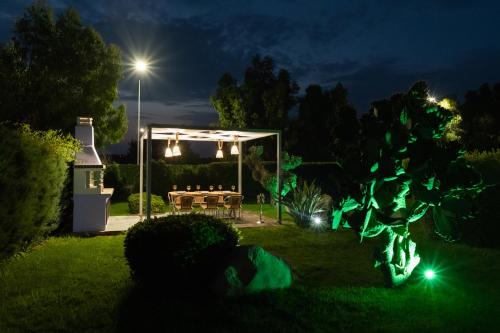 a garden lit up at night with a gazebo at Palamoutaki Villa in Koskinou