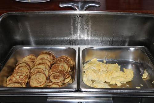 a tray of food with bread and eggs in it at Intitambo Hotel in Ollantaytambo