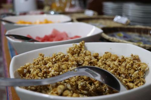 a bowl of food with a spoon in it at Intitambo Hotel in Ollantaytambo
