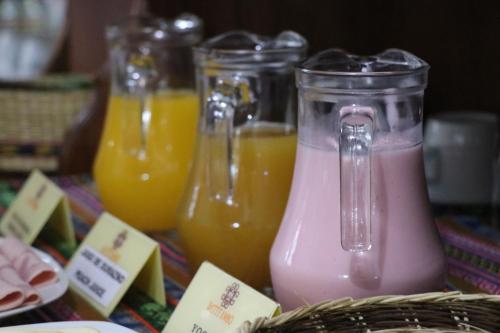 a group of three different types of juice at Intitambo Hotel in Ollantaytambo
