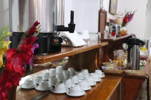 a group of white cups sitting on a table at Intitambo Hotel in Ollantaytambo