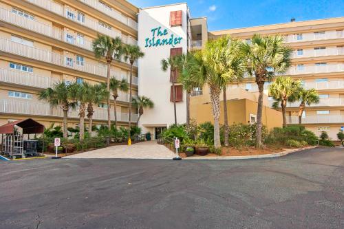 a large building with palm trees in front of it at The Islander 412 in Destin