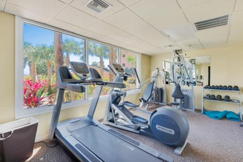 a gym with cardio machines and a window at The Islander 412 in Destin