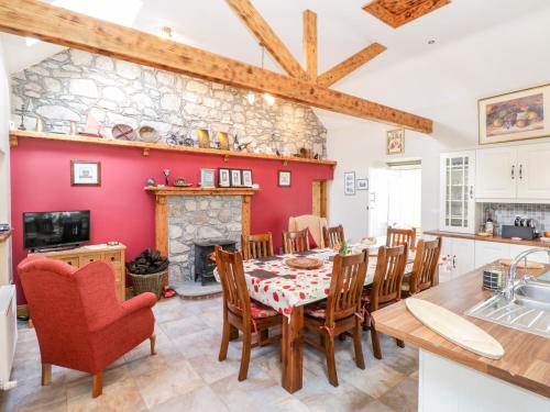 a kitchen and dining room with a table and chairs at Prague House in Lettermore