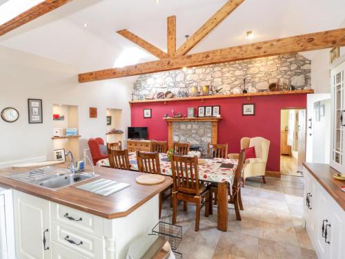 a kitchen and dining room with a table and chairs at Prague House in Lettermore