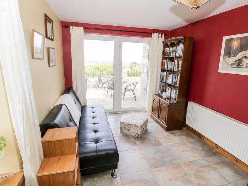 a living room with a couch and a book shelf at Prague House in Lettermore