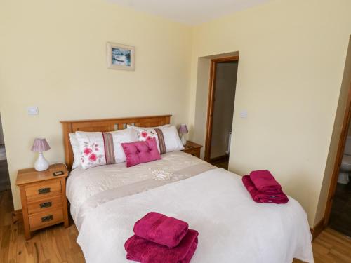 a bedroom with a bed with two towels on it at Prague House in Lettermore