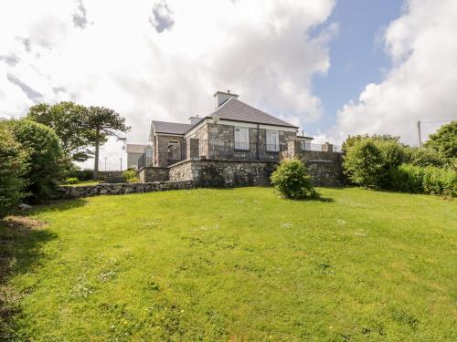 a house on top of a grassy field at Prague House in Lettermore