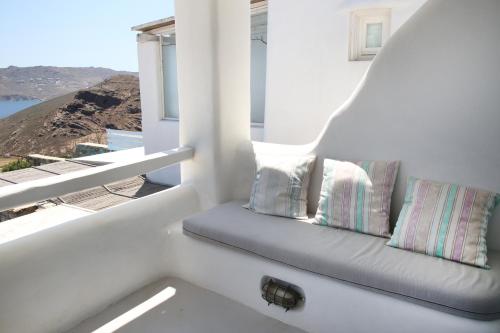 a bench sitting in a room with a window at Villa ANASA private Pool & Jacuzzi 8pax at Panormos in Panormos Mykonos