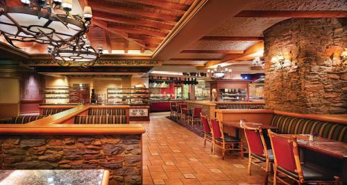 a restaurant with a bar with tables and chairs at Ameristar Casino Black Hawk in Black Hawk