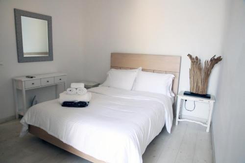 a bedroom with a bed with two towels on it at Villa ANASA private Pool & Jacuzzi 8pax at Panormos in Panormos Mykonos