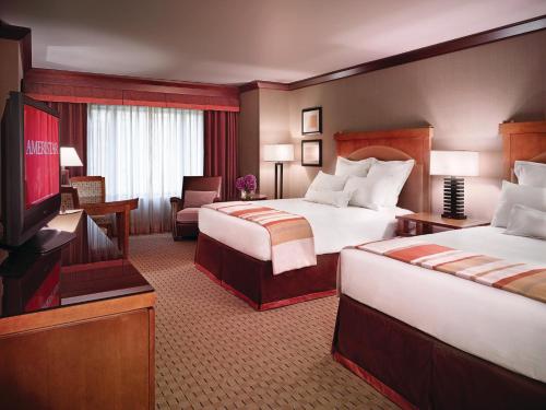 a hotel room with two beds and a television at Ameristar Casino Black Hawk in Black Hawk