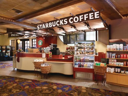 a starbucks coffee store with a counter and chairs at Ameristar Casino Black Hawk in Black Hawk