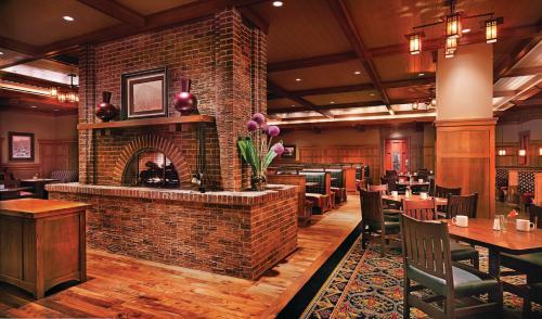 a restaurant with a brick fireplace and tables and chairs at Ameristar Casino Black Hawk in Black Hawk