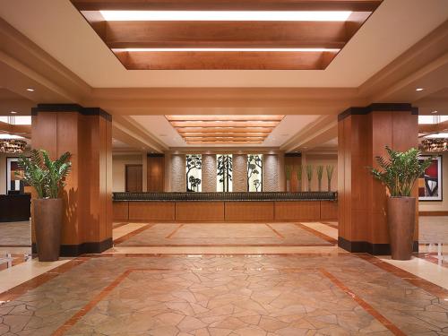 a lobby of a hotel with pillars and plants at Ameristar Casino Black Hawk in Black Hawk