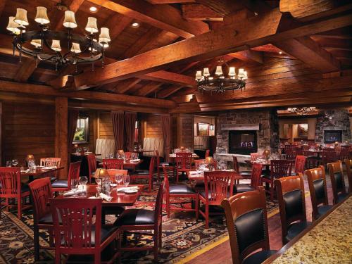 a restaurant with wooden ceilings and tables and chairs at Ameristar Casino Black Hawk in Black Hawk
