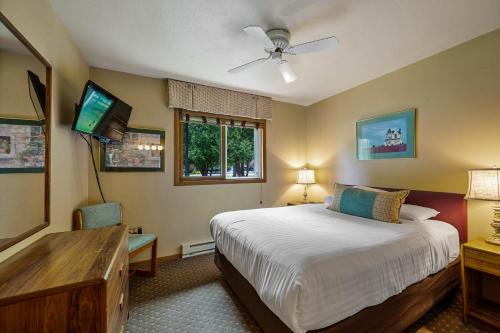 a bedroom with a bed and a flat screen tv at Somerset Inn & Suites in Ephraim