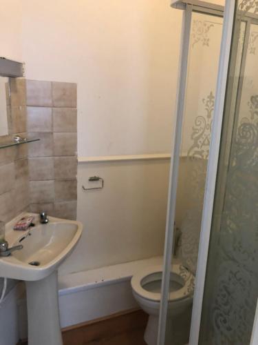 a bathroom with a toilet and a sink and a shower at Sky city hotel in Blackpool
