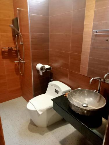 a bathroom with a toilet and a sink at Blue Orchid Beach Krabi - SHA Certified in Ao Nam Mao